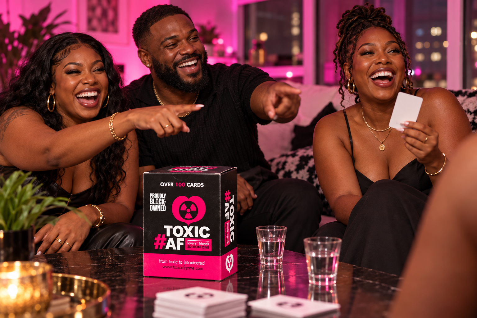 Three adult friends laughing and reacting during a Toxic AF game